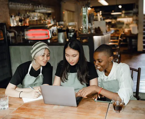 restaurant workers working on laptop